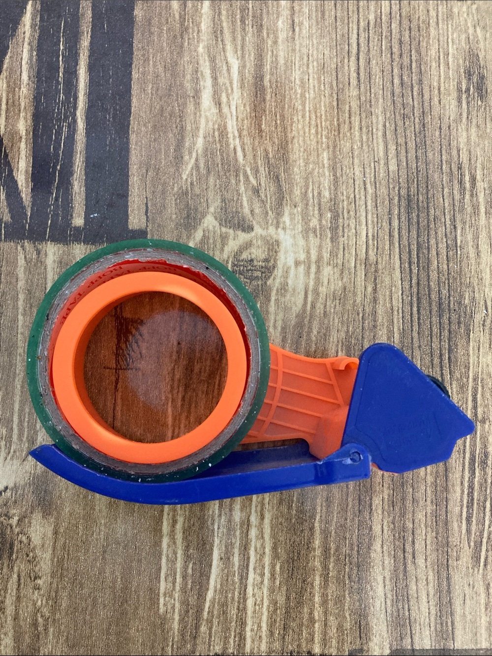 Handheld Tape Dispenser with Orange Core and Blue Handle